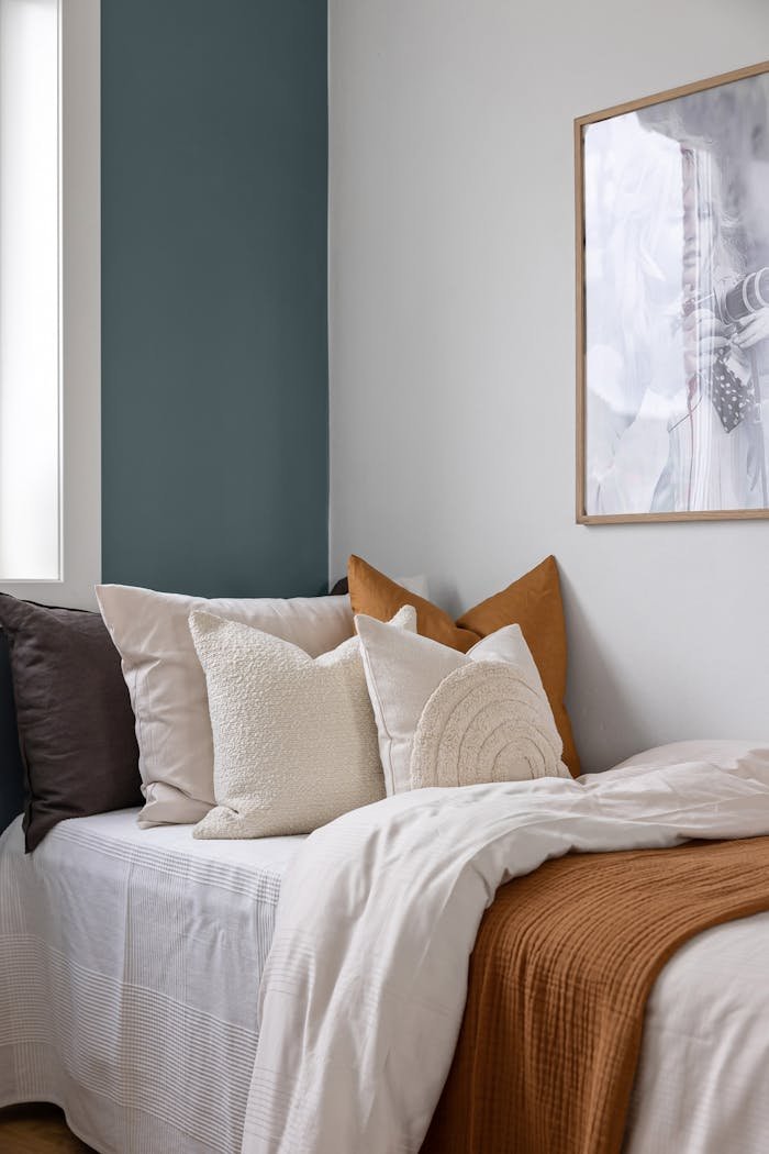 Services-03 A tranquil bedroom setting with plush pillows and soft linens, ideal for relaxation.